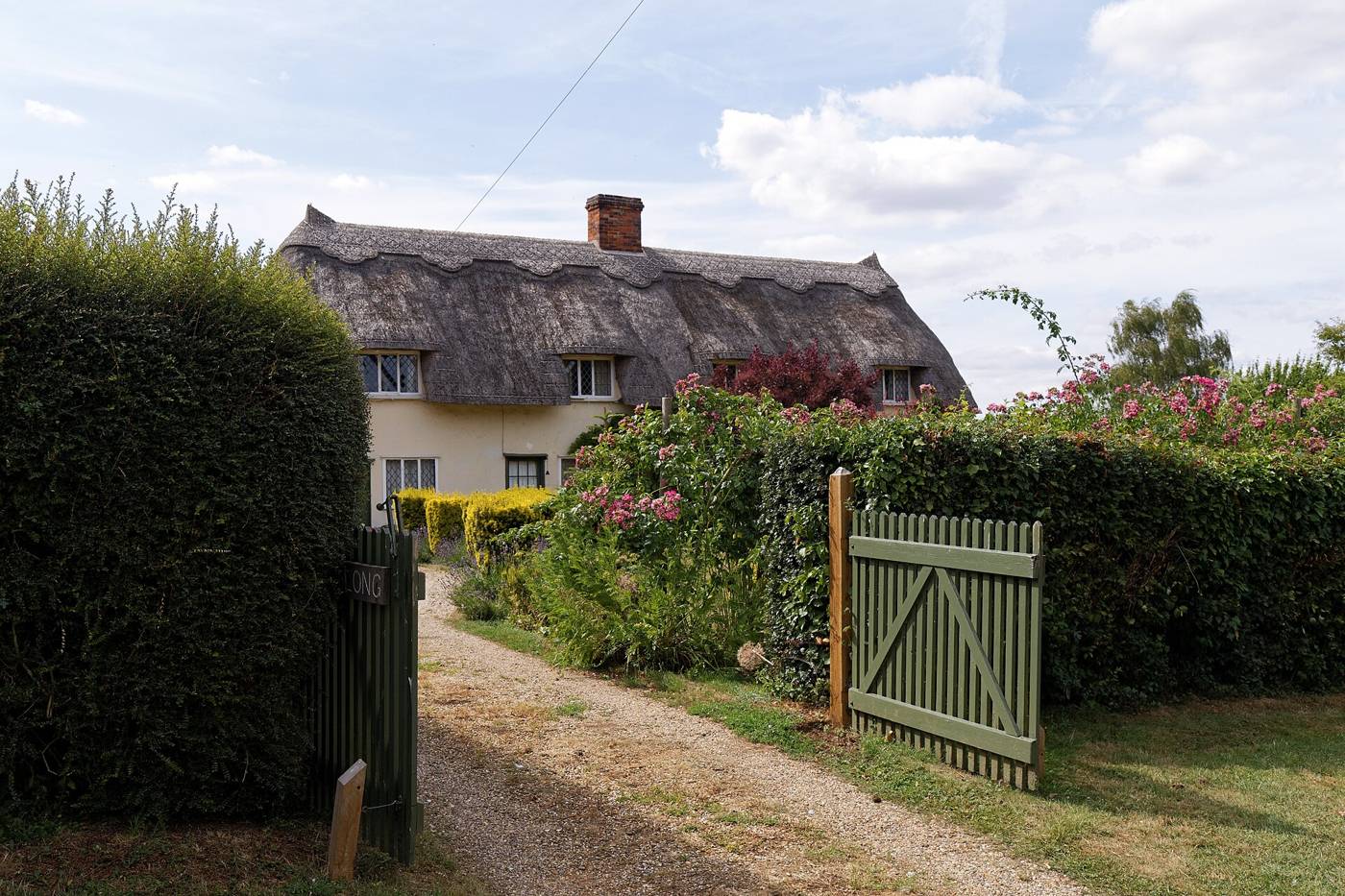 Wooden gate across a gravel drive
