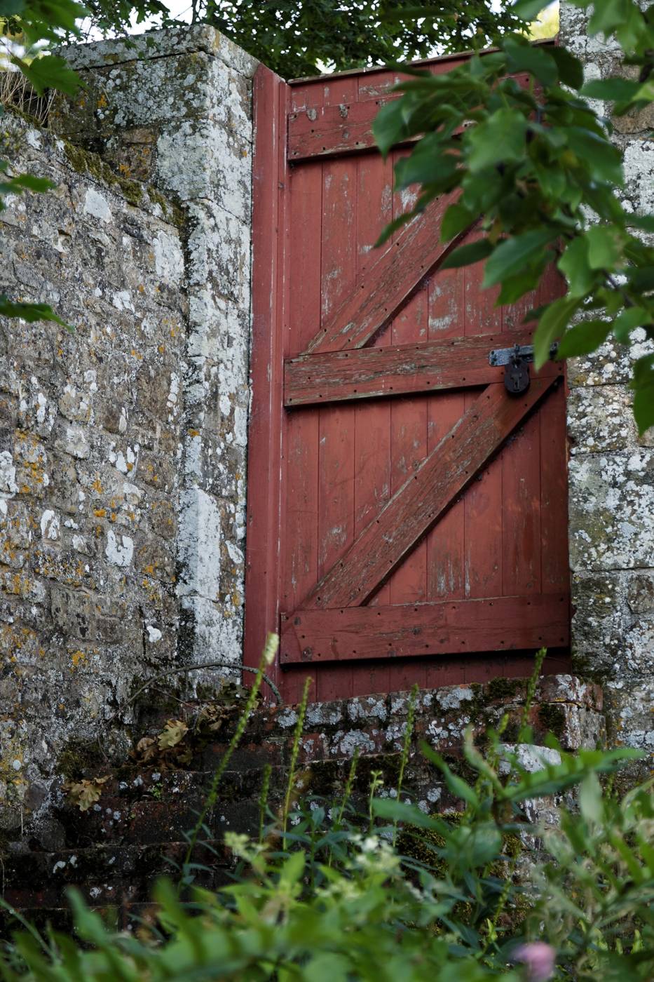 Wooden garden gate in a brick wall