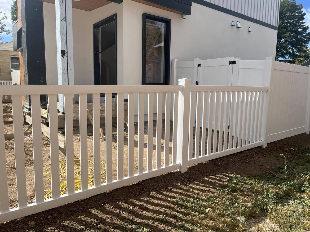 White vinyl fence beside a home
